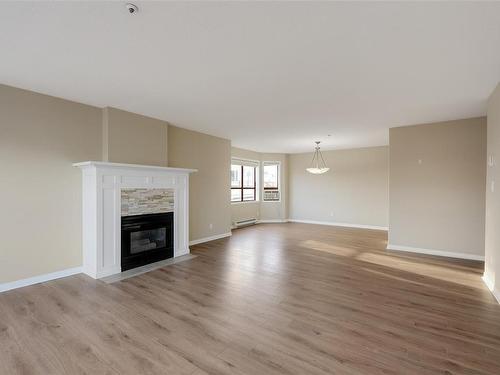 205-9711 Fifth St, Sidney, BC - Indoor Photo Showing Living Room With Fireplace