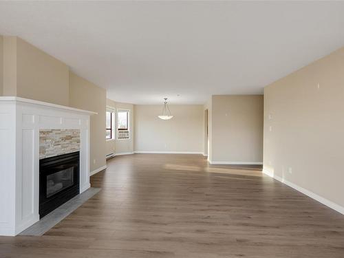 205-9711 Fifth St, Sidney, BC - Indoor Photo Showing Living Room With Fireplace