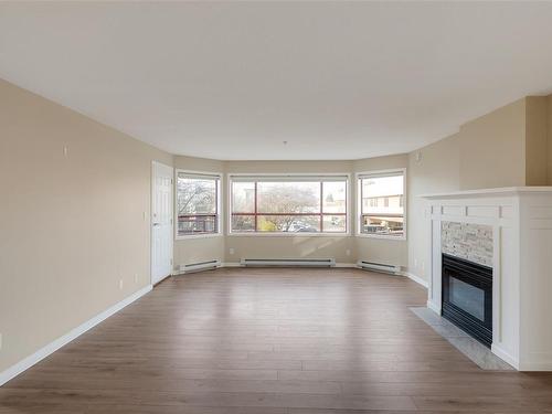 205-9711 Fifth St, Sidney, BC - Indoor Photo Showing Living Room With Fireplace