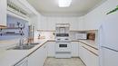 215-400 Sutton Crescent, Kelowna, BC  - Indoor Photo Showing Kitchen With Double Sink 