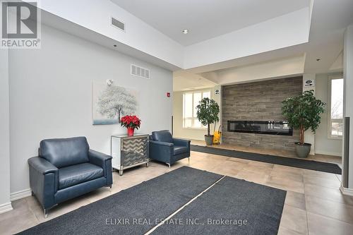 410 - 1360 Costigan Road, Milton, ON - Indoor Photo Showing Living Room With Fireplace