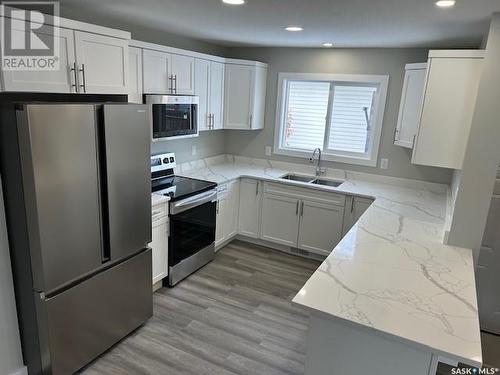 34 Bligh Bay, Regina, SK - Indoor Photo Showing Kitchen With Double Sink