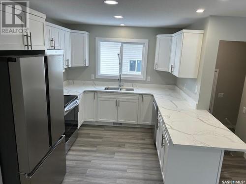 34 Bligh Bay, Regina, SK - Indoor Photo Showing Kitchen With Double Sink