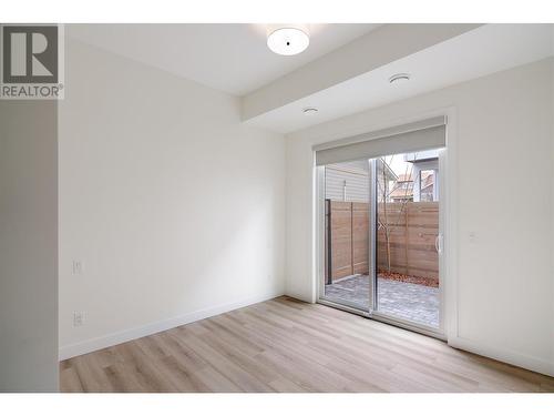 Bedroom #2 - a fantastic size with access to the fully fenced patio - 888 Patterson Avenue, Kelowna, BC - Indoor Photo Showing Other Room