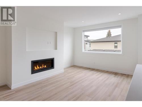 Gas fireplace in the living room - 888 Patterson Avenue, Kelowna, BC - Indoor Photo Showing Living Room With Fireplace