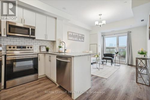 334 - 128 Grovewood Common, Oakville, ON - Indoor Photo Showing Kitchen With Stainless Steel Kitchen With Upgraded Kitchen