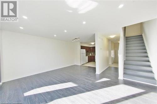 Spare room with dark hardwood / wood-style floors - 11 Sorrento Street, Kitchener, ON - Indoor Photo Showing Other Room