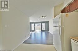 Kitchen with light hardwood / wood-style floors and white appliances - 