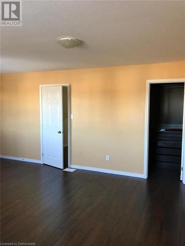 Empty room with a textured ceiling and dark hardwood / wood-style flooring - 11 Sorrento Street, Kitchener, ON - Indoor Photo Showing Other Room