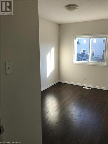 Spare room with dark wood-type flooring - 11 Sorrento Street, Kitchener, ON - Indoor Photo Showing Other Room