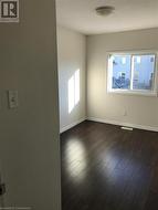 Spare room with dark wood-type flooring - 