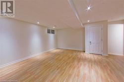 Basement with light hardwood / wood-style floors - 