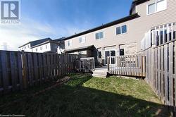 Rear view of house featuring a yard and a deck - 