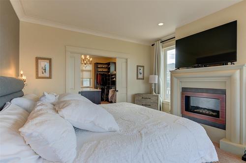 5335 Signet Crescent, Kelowna, BC - Indoor Photo Showing Bedroom With Fireplace