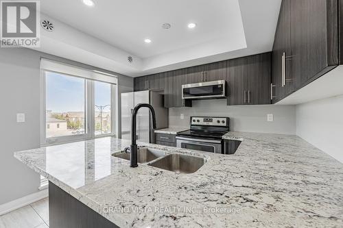 07 - 100 Dufay Road, Brampton, ON - Indoor Photo Showing Kitchen With Stainless Steel Kitchen With Double Sink With Upgraded Kitchen