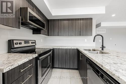 07 - 100 Dufay Road, Brampton, ON - Indoor Photo Showing Kitchen With Stainless Steel Kitchen With Double Sink With Upgraded Kitchen