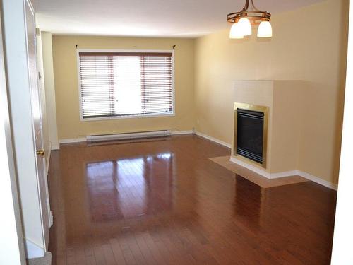 Living room - 9 Place De L'Orée, Châteauguay, QC - Indoor Photo Showing Other Room With Fireplace