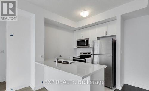 405 - 450 Dundas Street E, Hamilton (Waterdown), ON - Indoor Photo Showing Kitchen With Double Sink