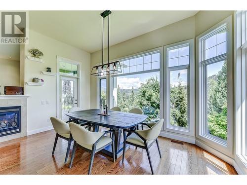 2168 Chilcotin Crescent, Kelowna, BC - Indoor Photo Showing Dining Room With Fireplace