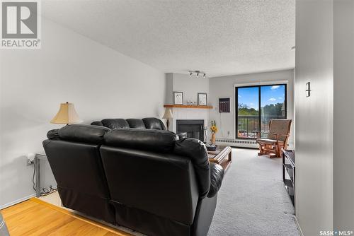 302 3420 Park Street, Regina, SK - Indoor Photo Showing Living Room With Fireplace