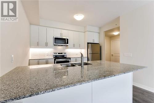 Kitchen - 150 Oak Park Boulevard Unit# 320, Oakville, ON - Indoor Photo Showing Kitchen With Stainless Steel Kitchen With Double Sink With Upgraded Kitchen