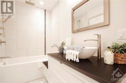 Ensuite with custom vanity. - 