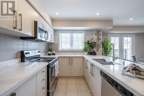 125 - 2441 Greenwich Drive, Oakville (West Oak Trails), ON - Indoor Photo Showing Kitchen With Double Sink