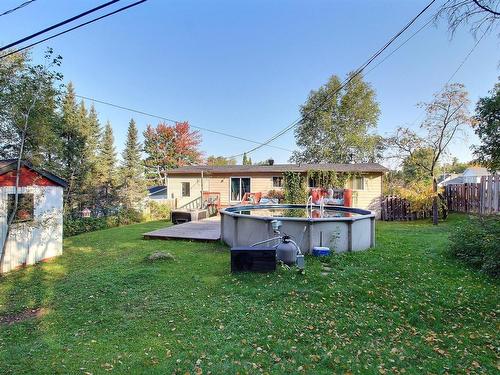 Back facade - 1537 Rue Labelle, Val-D'Or, QC - Outdoor With Above Ground Pool With Backyard