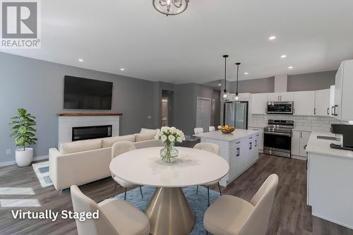 257 Shadow Mountain Boulevard, Cranbrook, BC - Indoor Photo Showing Dining Room With Fireplace