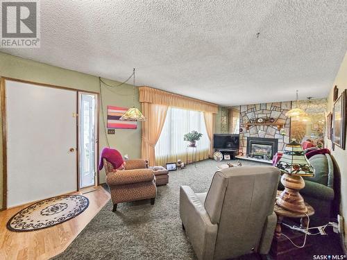 408 8Th Avenue W, Biggar, SK - Indoor Photo Showing Living Room With Fireplace