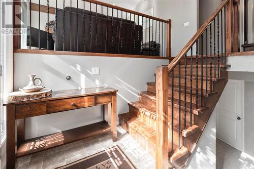 Front entrance with stairs up to the main level and down to the basement level - 209, 27475 Township Road 380, Rural Red Deer County, AB 