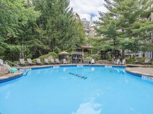 Pool - 425-100 Ch. De Kandahar, Mont-Tremblant, QC - Outdoor With In Ground Pool With Backyard