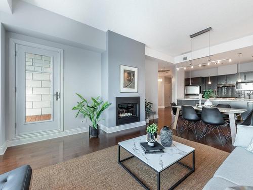 Overall view - 1303-333  - A Boul. Clairevue E., Saint-Bruno-De-Montarville, QC - Indoor Photo Showing Living Room With Fireplace