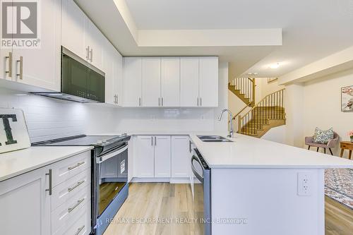 105 - 1577 Rose Way, Milton, ON - Indoor Photo Showing Kitchen With Double Sink With Upgraded Kitchen