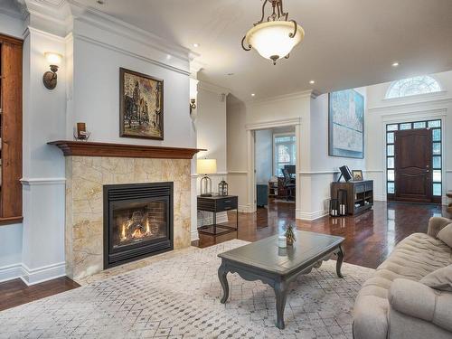 Living room - 14 Rue Sunrise, Hudson, QC - Indoor Photo Showing Living Room With Fireplace