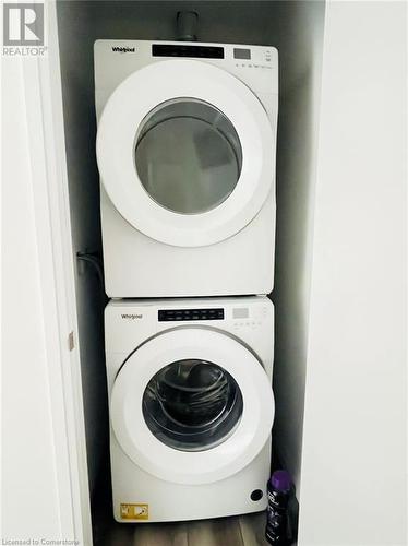 Laundry room featuring stacked washer / drying machine - 60 Charles Street Unit# 2205, Kitchener, ON - Indoor Photo Showing Laundry Room