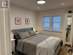 Bedroom featuring dark wood-type flooring - 