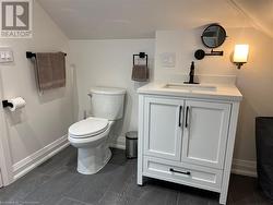 Bathroom with vanity, toilet, and vaulted ceiling - 