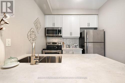 103 - 84 Aspen Springs Drive, Clarington, ON - Indoor Photo Showing Kitchen With Stainless Steel Kitchen With Double Sink