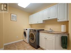 Laundry/Mud room with sink and built-in cabinets - 