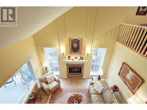 Living area view from upper level - 620 Arrowleaf Lane, Kelowna, BC - Indoor Photo Showing Living Room With Fireplace