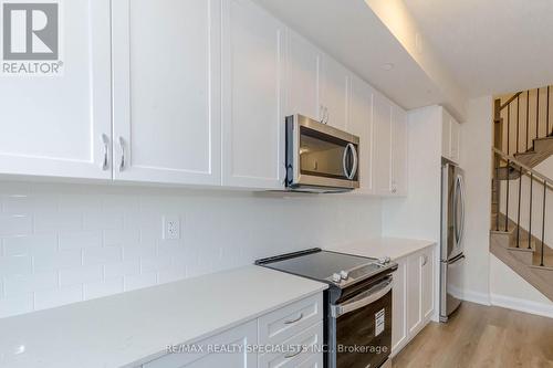 104 - 1597 Rose Way, Milton, ON - Indoor Photo Showing Kitchen With Stainless Steel Kitchen With Upgraded Kitchen