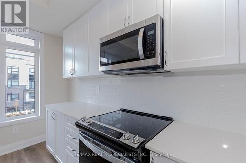 104 - 1597 Rose Way, Milton, ON - Indoor Photo Showing Kitchen With Upgraded Kitchen