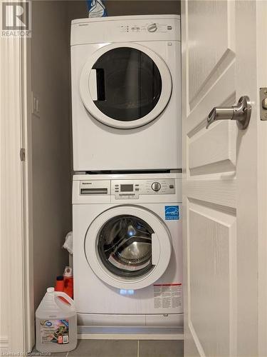 Laundry room featuring stacked washer and dryer - 9 Hyde Park Mews, Kitchener, ON - Indoor Photo Showing Laundry Room