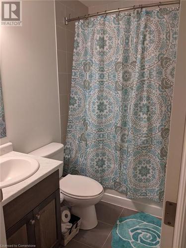 Full bathroom featuring tile patterned floors, vanity, shower / bath combination with curtain, and toilet - 9 Hyde Park Mews, Kitchener, ON - Indoor Photo Showing Bathroom