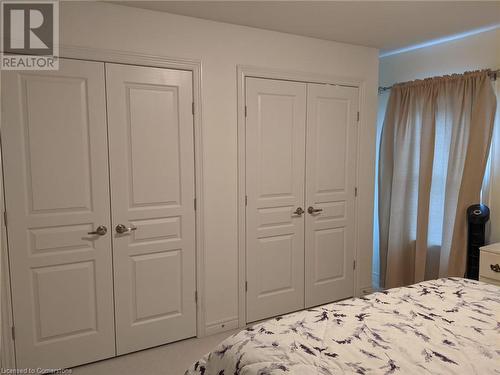 Carpeted bedroom featuring multiple closets - 9 Hyde Park Mews, Kitchener, ON - Indoor Photo Showing Bedroom