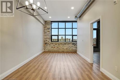 Living room with large south facing window - 15 Main Street Unit# 404, Cambridge, ON - Indoor Photo Showing Other Room