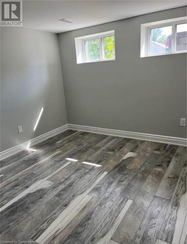 Unfurnished room featuring dark hardwood / wood-style flooring and a wealth of natural light - 155 Norfolk Avenue, Cambridge, ON - Indoor Photo Showing Other Room