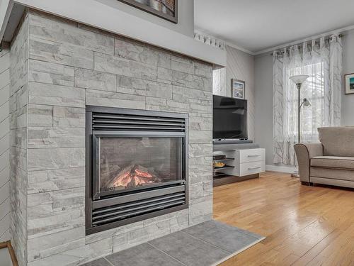 Living room - 6039 Av. Royale, L'Ange-Gardien, QC - Indoor Photo Showing Living Room With Fireplace