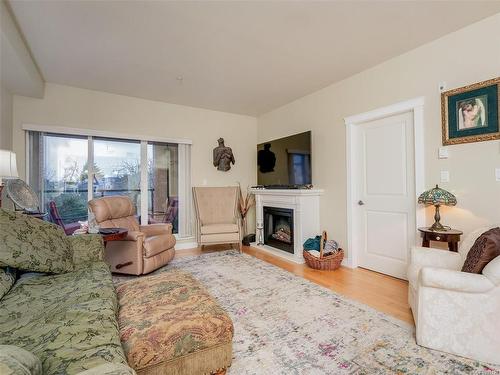 204-2380 Brethour Ave, Sidney, BC - Indoor Photo Showing Living Room With Fireplace